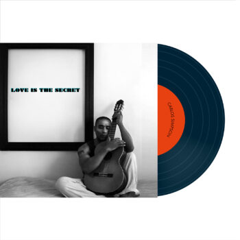 Album cover for Love Is The Secret by Carlos Simpson, released on November 29, 2020, under Carlos Simpson Music Production. The black-and-white design features the artist sitting on a bed, embracing an acoustic guitar in a heartfelt pose. The album title appears boldly in blue within a picture frame on the wall. This emotional and minimalist cover reflects the album’s intimate and soulful acoustic style. Keywords: Carlos Simpson album, acoustic music, emotional cover art, Love Is The Secret 2020.