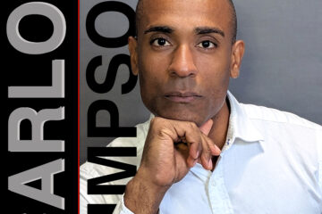Portrait of Carlos Simpson, a mentor, coach, and creative professional. He wore a white shirt and posed with a thoughtful expression, hand resting under his chin. His name “CARLOS SIMPSON” is displayed in large vertical and horizontal black and grey text beside him on a dark grey background.